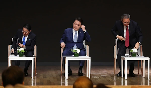 Japanese Prime Minister Fumio Kishida, from left, South Korean President Yoon Suk Yeol, and Chinese Premier Li Qiang attend a business meeting at the Korea Chamber of Commerce and Industry in Seoul, South Korea, May 27, 2024 (AP)