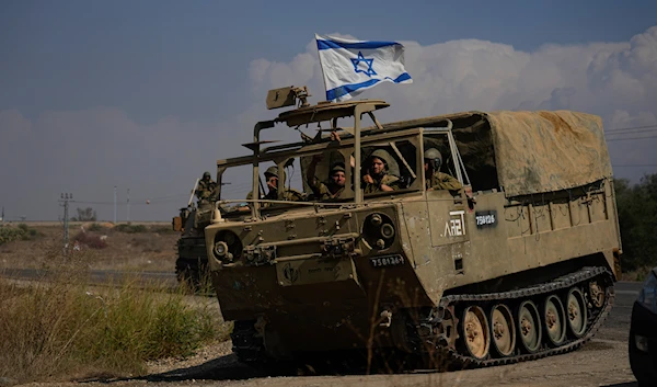 IOF troops wave their national flag as they move towards the Gaza Strip border in southern occupied Palestine on Wednesday, Nov.1, 2023. (AP)