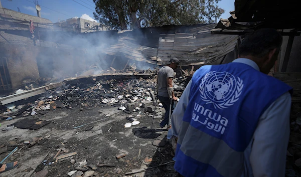 Palestinians look at the destruction after an Israeli strike on a school run by UNRWA, the UN agency helping Palestinian refugees, in Nuseirat, Gaza Strip, Tuesday, May 14, 2024. (AP)