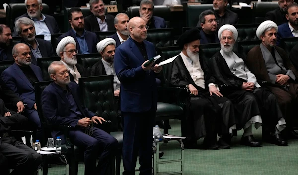 Mohammad Bagher Qalibaf, center, takes an oath during the opening ceremony of the new parliament term in Tehran, Iran, May 27, 2024 (AP)