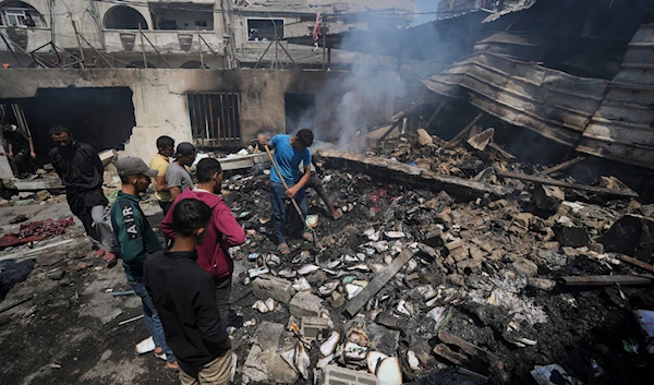 Palestinians search debris after an Israeli strike on a school run by UNRWA, the UN agency helping Palestinian refugees, in al-Nuseirat, Gaza Strip, Tuesday, May 14, 2024. (AP)