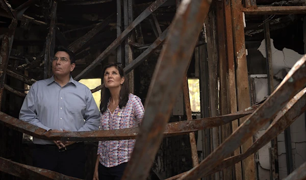 Danny Danon, a member of the Knesset, and Nikki Haley, former US Ambassador to the UN, visit a home in Kibbutz Nir Oz on Monday, May 27, 2024. (AP)