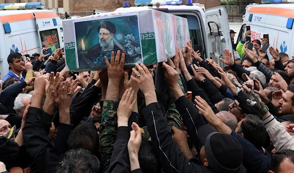 Mourners carry the flag-draped coffin of President Ebrahim Raisi during a funeral ceremony for him and his companions in the city of Tabriz, Iran, May 21, 2024 (AP)