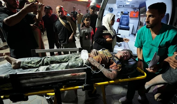 A Palestinian wounded in an Israeli bombardment on the Gaza Strip is brought to Al Aqsa hospital in Deir al Balah, central Gaza Strip, on Sunday, May 26, 2024. (AP)