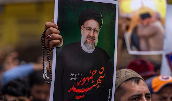 A photograph of late Iranian President Ebrahim Raisi during a solidarity march in Kashmir, May 24, 2024. (AP)