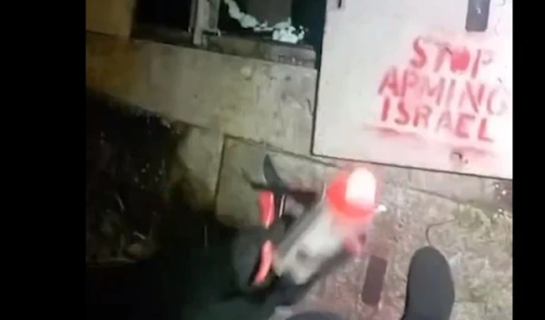 A screenshot of the Palestine Action activists spray painting on the electric cable cabinet of the Leonardo factory in Scotland on May 29, 2024 (X/@Pal_Action)