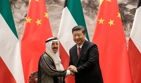 Kuwait's Emir Sabah al-Ahmed al-Sabah, left, shakes hands with Chinese President Xi Jinping after a signing ceremony in Beijing, China, July 9. (AP/Pool)