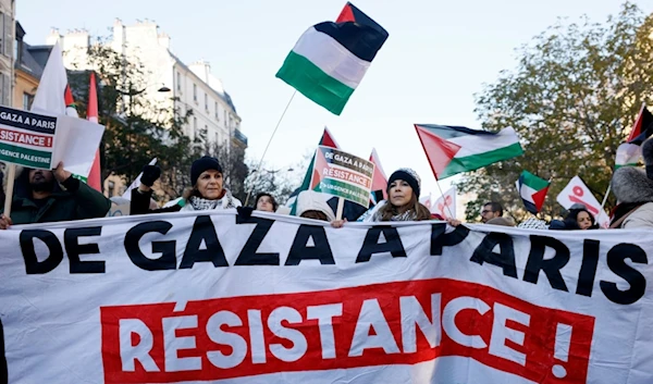 People chant slogans holding banners that reads 'From Gaza to Paris - Residence - Emergency Palestine' during a pro-Palestinian rally, in Paris, France, Dec. 2, 2023. (AP)