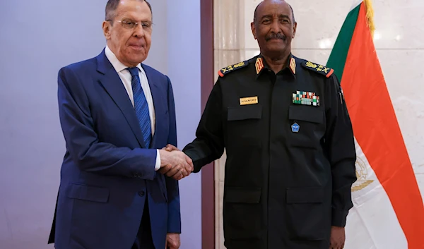 In this photo released by Russian Foreign Ministry Press Service, Russian Foreign Minister Sergey Lavrov, left, and Sudan's Army chief Gen. Abdel-Fattah Burhan pose for a photo during their meeting in Khartoum, Sudan, on February 9, 2023. (AP)