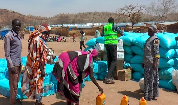 Sudanese refugees displaced by the conflict in Sudan gather to receive food staples from aid agencies at the Metche Camp in eastern Chad, on Tuesday, March 5, 2024. (AP)