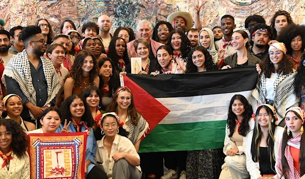 Cuban PresidentMiguel Diaz-Canel stands amongst pro-Palestine supporters with the Palestinian flag held proudly in the center in an undated image. (Social media)