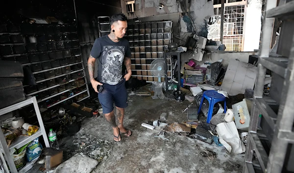 The owner of a pet shop surveys damage after a fire at Chatuchak Weekend Market, one of the most famous markets in Bangkok, Thailand, on June 11, 2024. (AP)