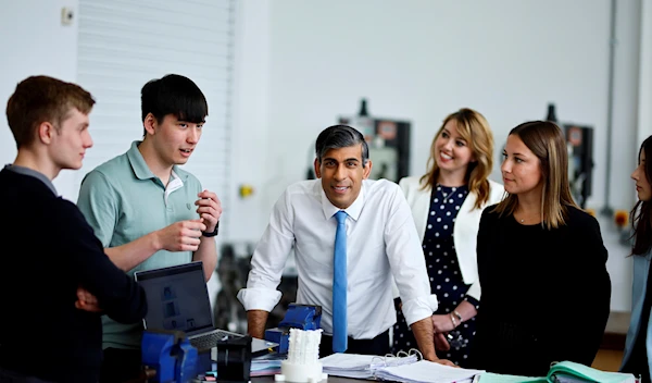 Britain's Prime Minister and Conservative Party leader Rishi Sunak speaks with students during a visit of University Technical College (UTC) in Silverstone, England, Tuesday June 11, 2024 (AP)