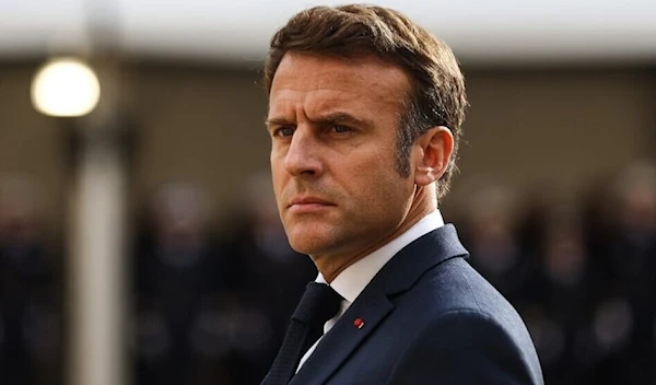 French President Emmanuel Macron looks on as he attends a tribute ceremony to veterans of the Algerian War, at the Hotel National des Invalides, in Paris on October 18, 2022. (AFP)