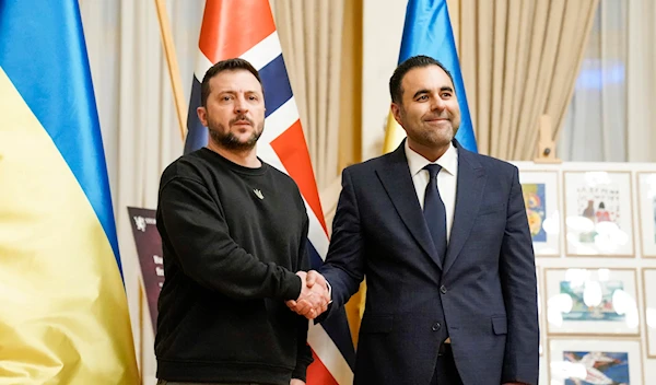 Ukrainian President Volodymyr Zelenskyy, left, and Norway's Parliament Speaker Masud Gharahkhani shake hands in the Storting in Oslo, Norway, Wednesday Dec. 13, 2023. (AP)