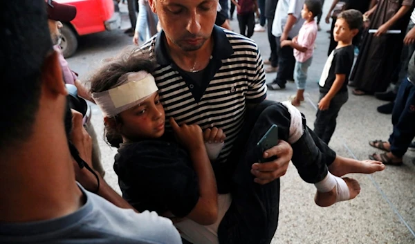 A Palestinian child wounded in an Israeli bombardment on a residential building owned by the Jabr family in Bureij refugee camp, is brought to al-Aqsa Martyrs Hospital in Deir al Balah, central Gaza Strip, Wednesday, June 12, 2024. (AP)