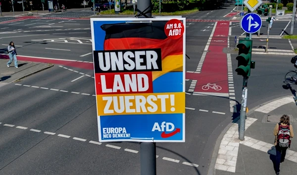 An election poster of German far right AfD party is fixed on a lamp pole in Frankfurt, Germany, Monday, June 10, 2024. (AP Photo/Michael Probst)