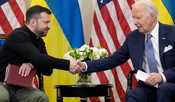 U.S. President Joe Biden shakes hands with Ukrainian President Volodymyr Zelenskyy in Paris, on June 7, 2024. (AP)