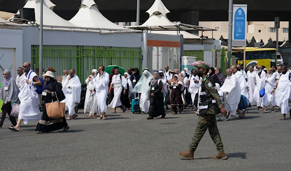 Muslim pilgrims arrive at the Mina tent camp during the annual Hajj pilgrimage, near the holy city of Mecca, Saudi Arabia, June 14, 2024 (AP)