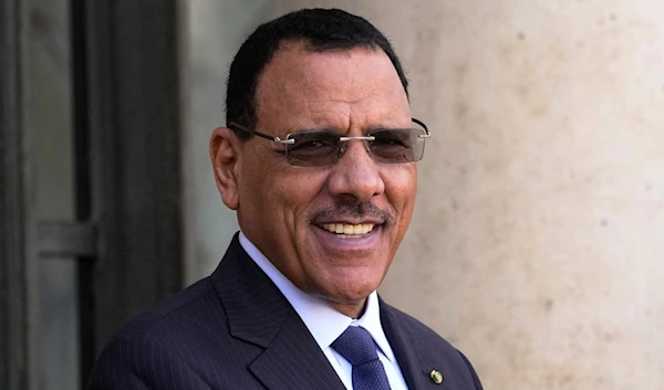 Niger's ousted President Mohamed Bazoum smiles before a working lunch with French President Emmanuel Macron, Feb. 16, 2023 at the Elysee Palace in Paris (AP)