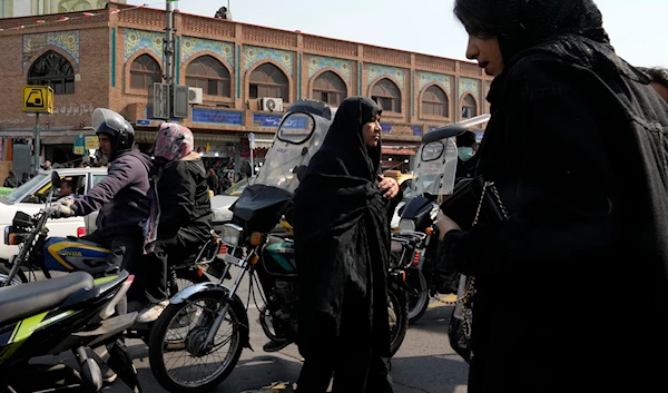 People cross an intersection in downtown Tehran, Iran, March 2, 2024 (AP)