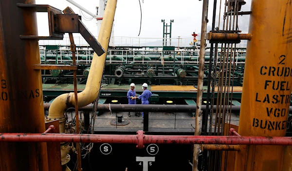 Crewmen speak aboard the Iranian oil tanker Fortune during its arrival at El Palito refinery near Puerto Cabello, Venezuela, May 25, 2020 (AP)