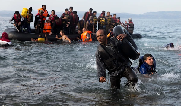 Migrants and refugees arrive on a dinghy after crossing from Turkey to Lesbos island, Greece, on September 9, 2015. (AP)