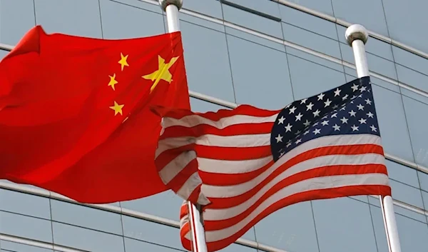 A US and a Chinese flag wave outside a commercial building in Beijing on July 9, 2007. (AFP/Getty Images)