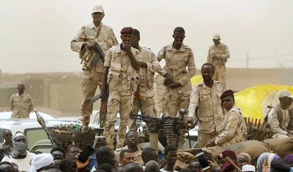 Sudanese soldiers from the Rapid Support Forces unit stand on their vehicle during a military-backed rally, in Mayo district, south of Khartoum, Sudan, Saturday, June 29, 2019. (AP)