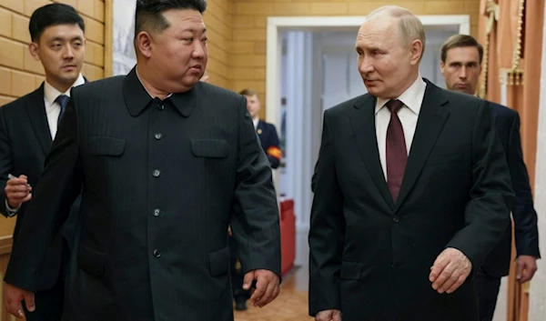 Russian President Vladimir Putin, right, and North Korea's leader Kim Jong Un talk to each other during their meeting in Pyongyang, North Korea, early Wednesday, June 19, 2024. (AP)