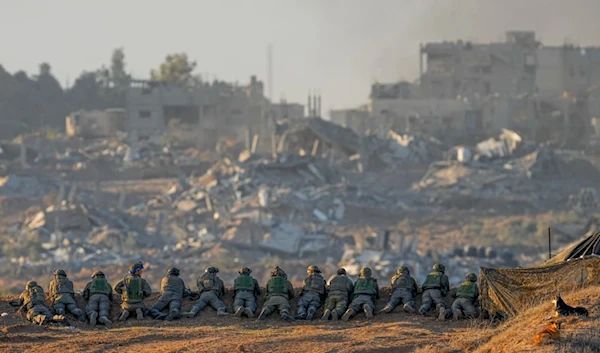 Israeli soldiers take positions near Gaza in southern occupied Palestine, on Dec. 11, 2023 (AP Photo)