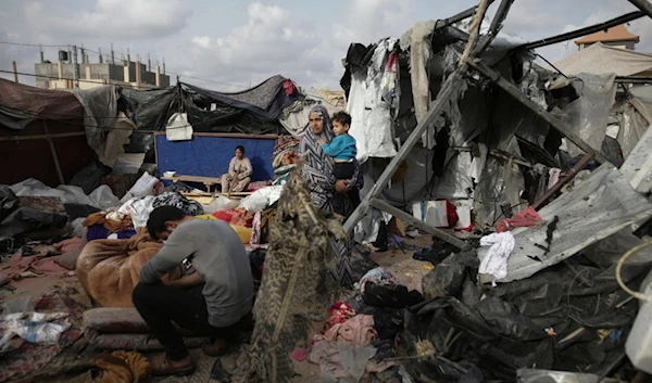 FILE - Displaced Palestinians inspect their tents destroyed by Israel's bombardment, adjunct to an UNRWA facility west of Rafah city, Gaza Strip, Tuesday, May 28, 2024. (AP)