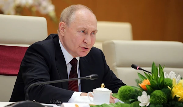 Russian President Vladimir Putin speaks to Vietnamese Prime Minister Pham Minh Chinh during a meeting at the government office in Hanoi, Vietnam Thursday, June 20, 2024. (AP)