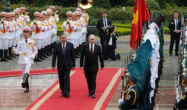 Vietnamese President To Lam, center left, and his Russian counterpart Vladimir Putin, center right, review the guard of honor at the Presidential Palace in Hanoi, Vietnam, on June 20, 2024. (AP)