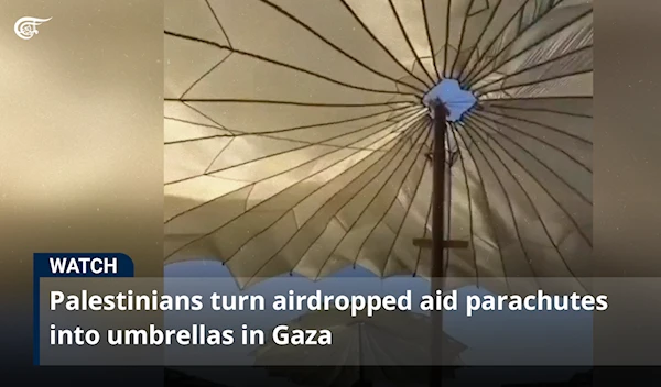 Palestinians turn airdropped aid parachutes into umbrellas in Gaza