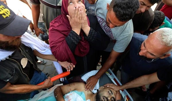 Palestinians mourn their relative Tamer Mohsen killed in the Israeli bombardment of Nuseirat refugee camp, at the morgue of al-Aqsa Martyrs hospital in Deir al Balah, central Gaza Strip, Wednesday, June 19, 2024. (AP)