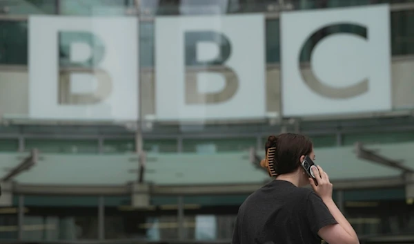 A woman walks outside the BBC Headquarters in London, Tuesday, July 11, 2023.  (AP)