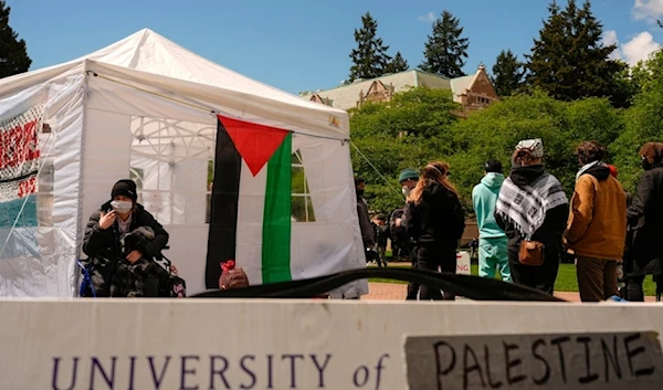 A sign is shown written over to read University of Palestine at A pro-Palestinian encampment on the University of Washington campus Monday April 29, 2024, in Seattle. (AP)