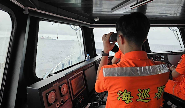 In this photo released by the Taiwan Coast Guard, a Taiwan Coast Guard member monitor Chinese navy vessel operating near the Pengjia Islet north of Taiwan on Thursday, May 23, 2024. (AP)