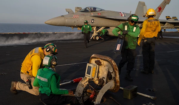 Crew members work during take off operations on the deck of the USS Dwight D. Eisenhower in the Red Sea on Tuesday, June 11, 2024. (AP)