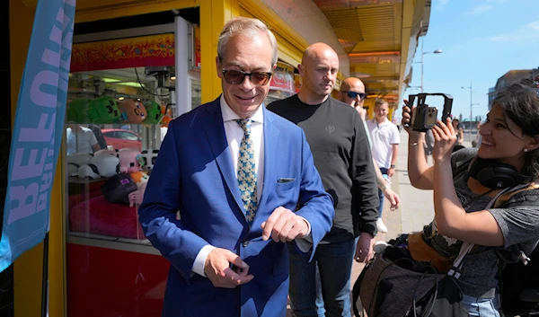 Britain's Nigel Farage, Reform UK party leader is filmed as he arrives at the Reform office to spend time with supporters in Clacton-On-Sea, Essex, England Friday, June 21, 2024. (AP)