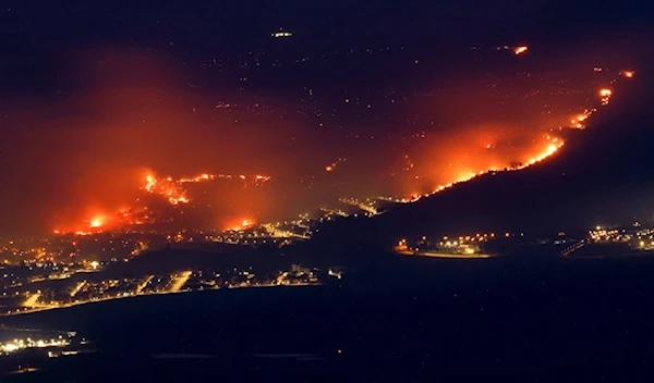 Fires burn around and in Kiryat Shmona near the Palestinian-Lebanese border, in occupied al-Jalil Panhandle, occupied Palestine, on June 3, 2024. (AFP)