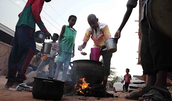 People prepare food in a Khartoum neighborhood on June 16, 2023. (AP)