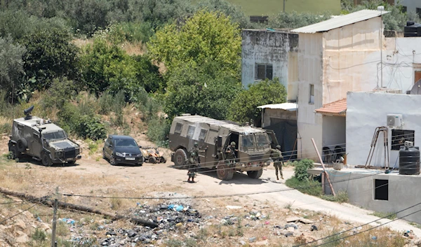 Israeli military soldiers are about to enter a house in the Palestinians Al Fara'a refugee camp in the occupied West Bank following an Israeli military raid, on June 10, 2024. (AP)