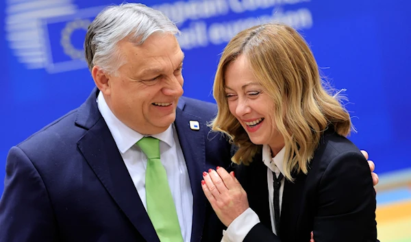 Hungary's Prime Minister Viktor Orban, left, speaks with Italy's Premier Giorgia Meloni during a round table meeting at an EU Summit in Brussels, on March 21, 2024. (AP)