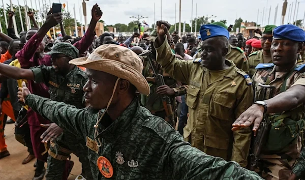 Niger's National Council for the Safeguard of the Homeland Colonel-Major Amadou Abdramane, second from right, is greeted by supporters upon his arrival at the Stade General Seyni Kountche in Niamey on August 6, 2023. (AFP/Getty Images