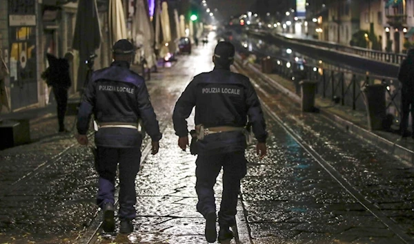 Two city police officers patrol the Navigli area, a popular evening spot of restaurants and pubs bordering canals in Milan, Italy, Thursday, Oct. 22, 2020. (AP)