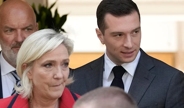 Right-wing National Rally party president Jordan Bardella, right, leaves with far-right leader Marine Le Pen after a press conference, Monday, June 24, 2024 in Paris. (AP)