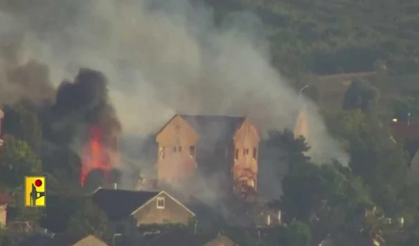 A screenshot from the Lebanese Resistance Military Media video showing a burning house in which Israeli occupation forces were targeted in Metula on June 24, 2024. (Military Media)