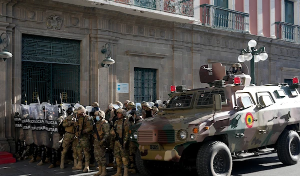 An armored vehicle and military police form outside the government palace at Plaza Murillo in La Paz, Bolivia, June 26, 2024 (AP)